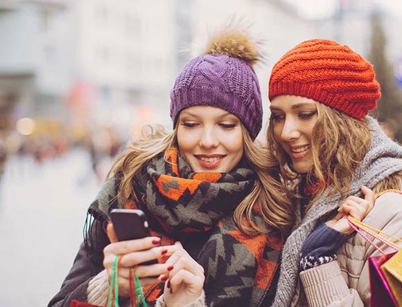 Women reviewing their personalized recommendations on a mobile device
